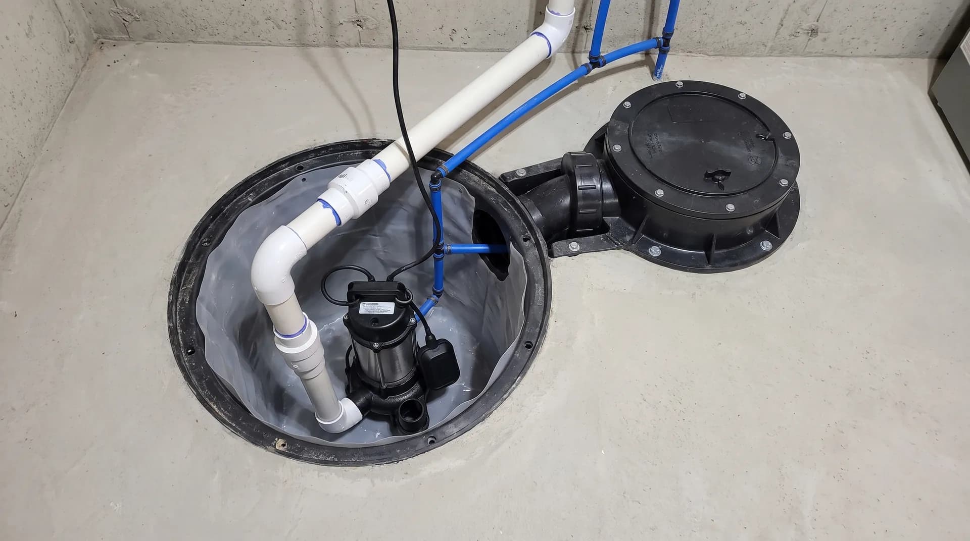 Sump pump and backwater valve installed to prevent basement flooding