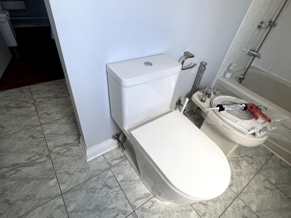 Plumber replacing a bathroom plumbing fixture