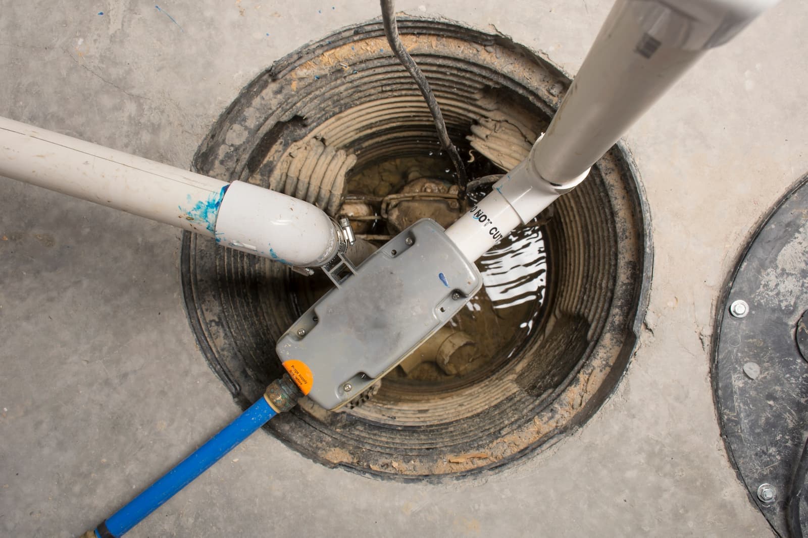 Sump pump installation in a residential basement pit