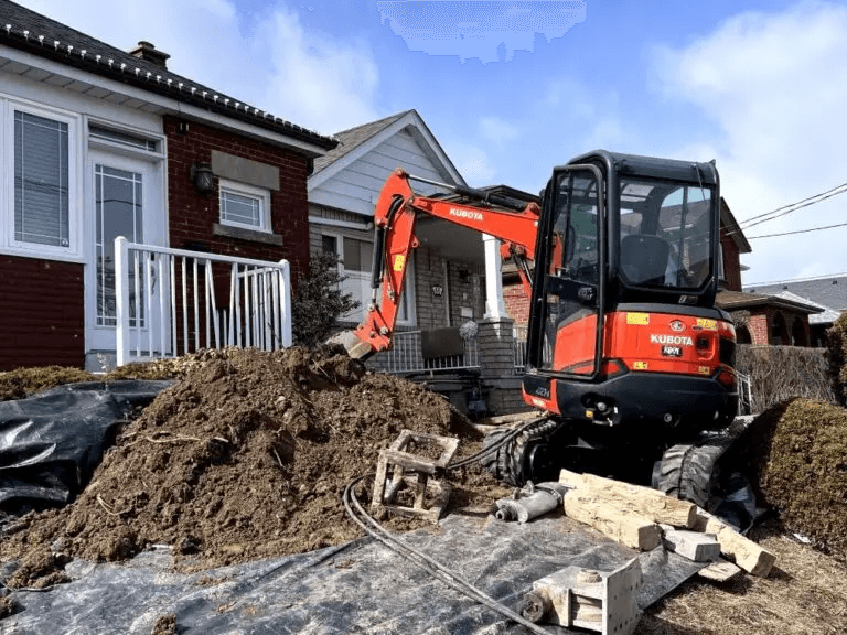 Mini excavator opening a residential lawn for a water service upgrade