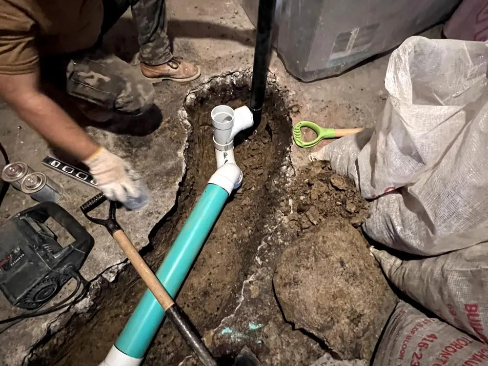 Technician repairing an underground residential drain line