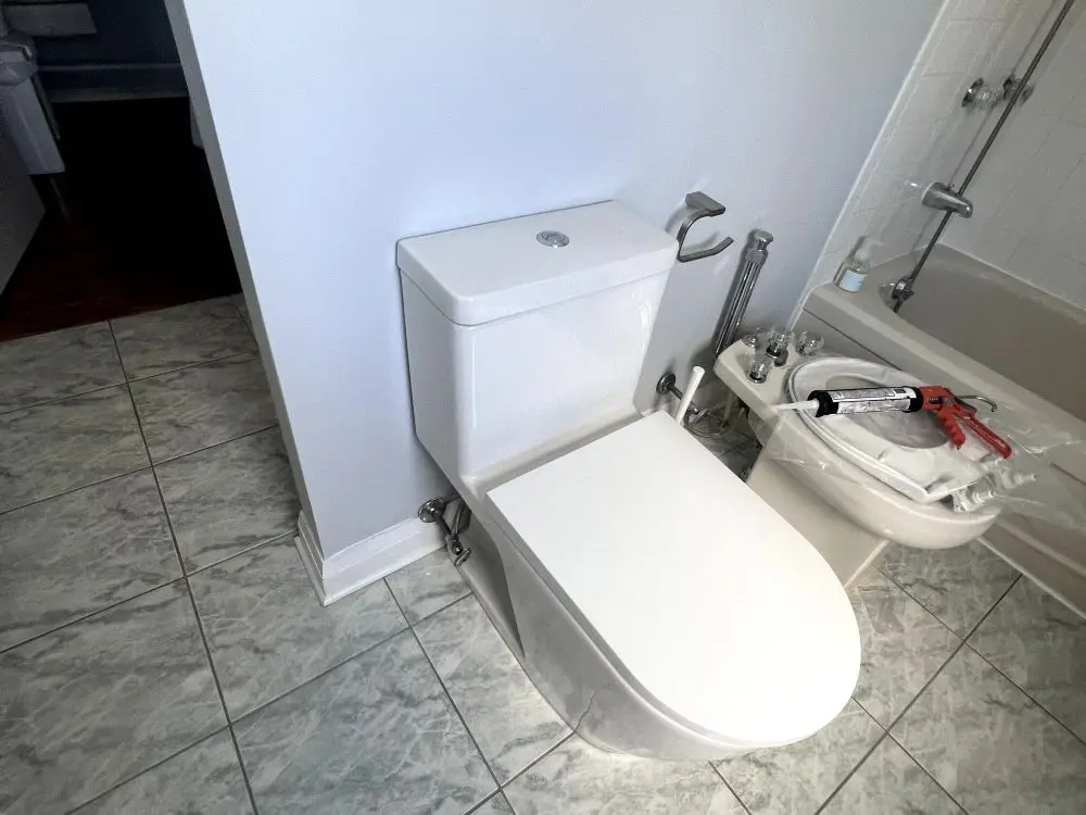 Plumber replacing a bathroom plumbing fixture